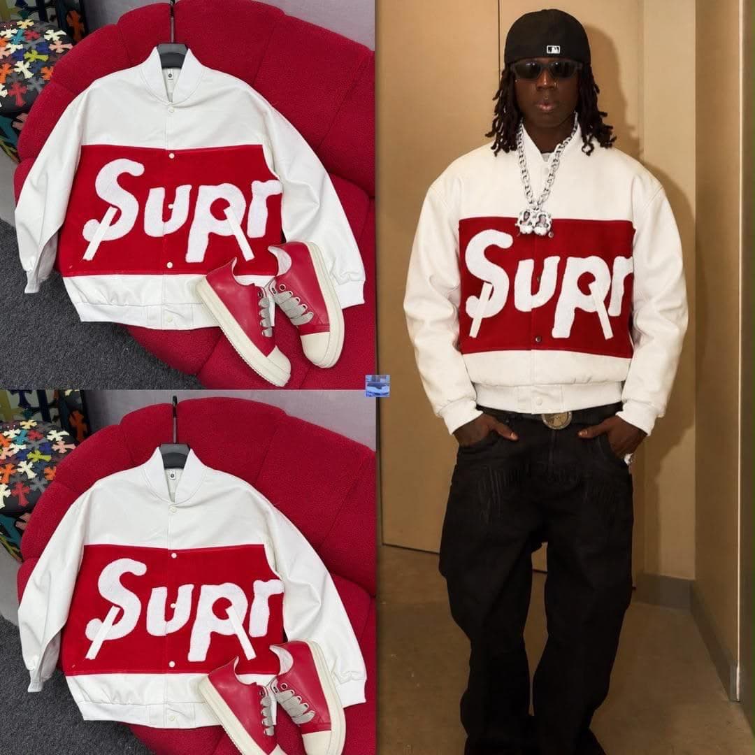 White and red Supr varsity bomber jacket flat lay with red sneakers and modeled with chain and cap.