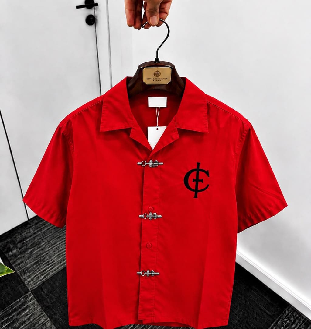 Red unisex short sleeve shirt with toggle buttons and black chest logo.