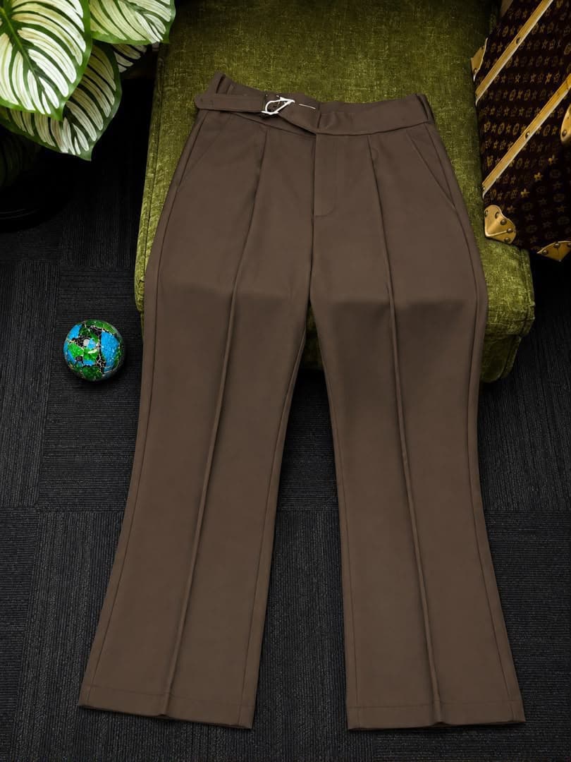 Front view of brown high-waisted flare trousers with belt.