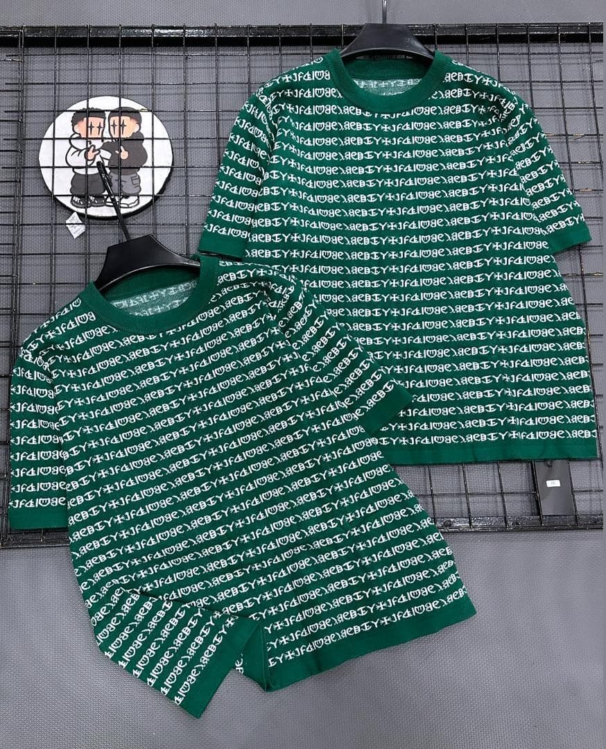 Green two-piece set with all-over repeating text print on short sleeve top and shorts.