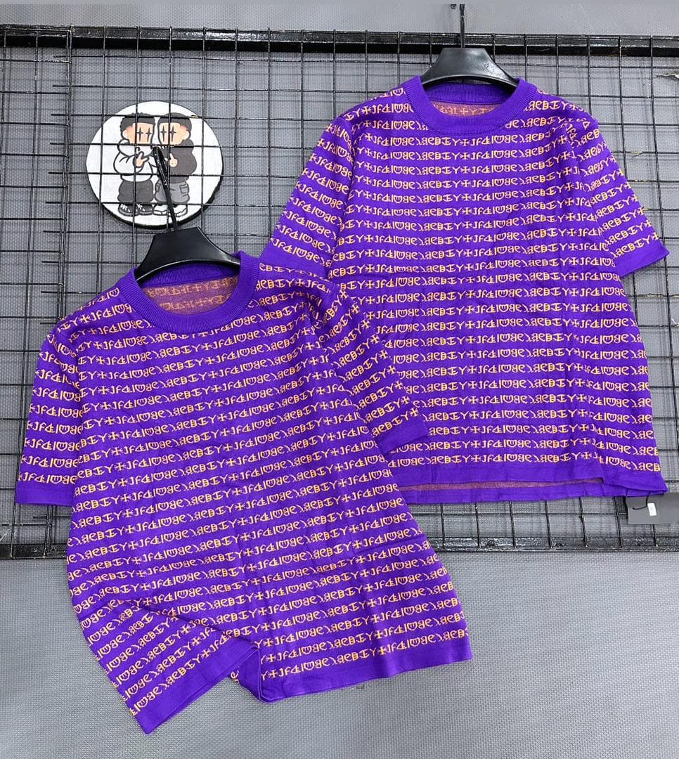 Purple two-piece set with all-over repeating text print on short sleeve top and shorts.