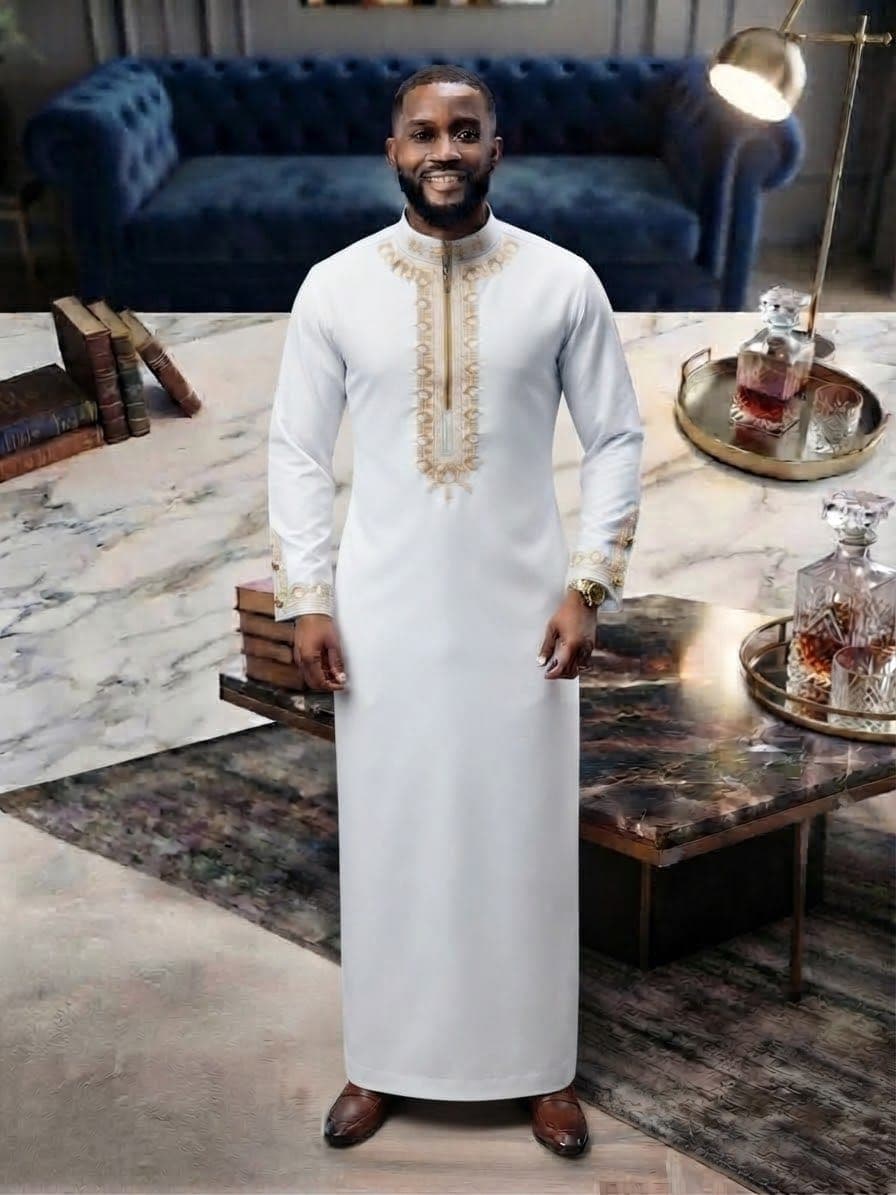 Model wearing white embroidered kaftan with gold embroidery.