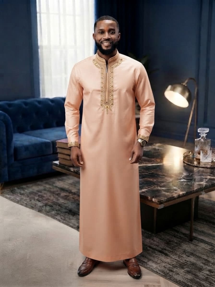Model wearing peach embroidered kaftan in elegant setting.