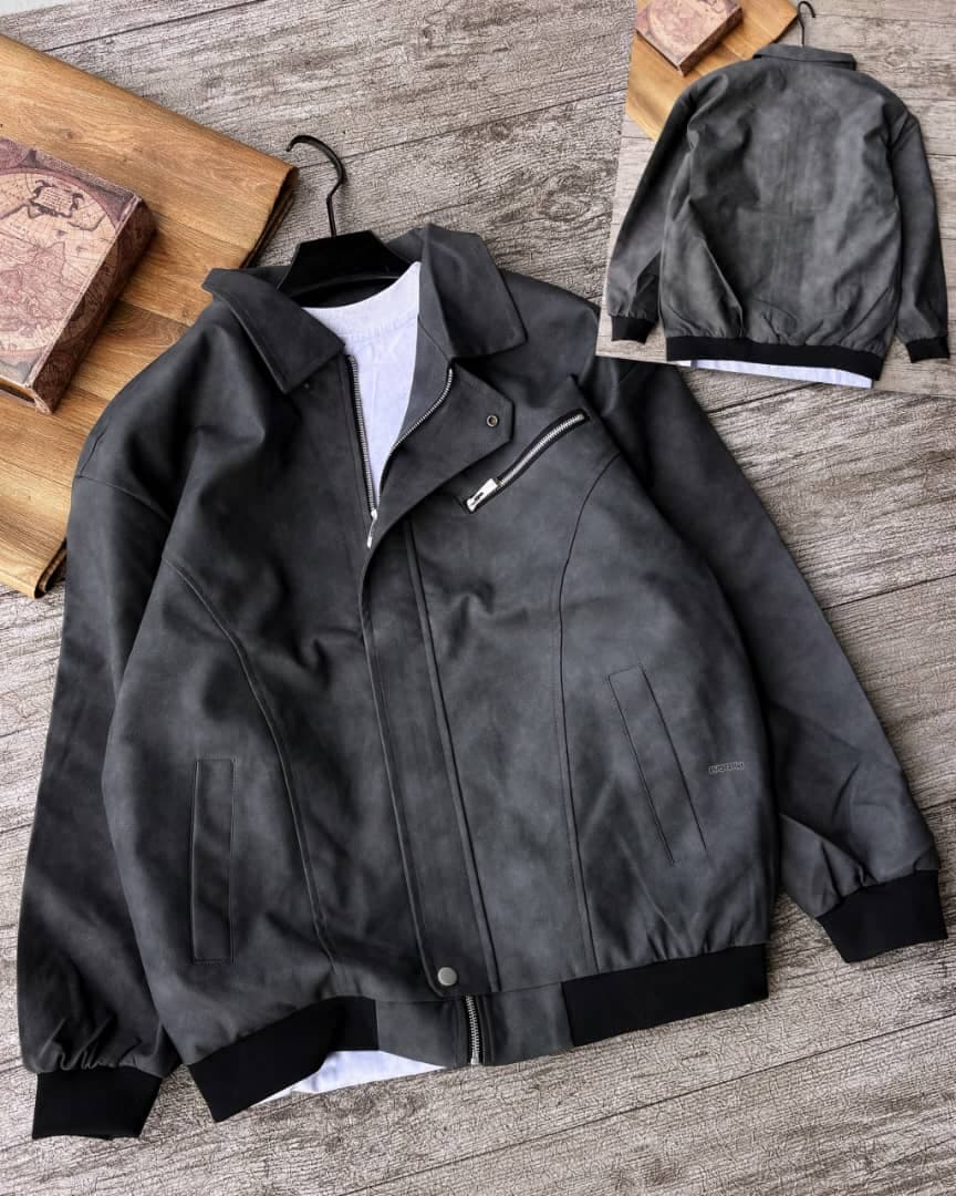 Black suede bomber jacket with contrasting trim and chest zip, back inset visible.