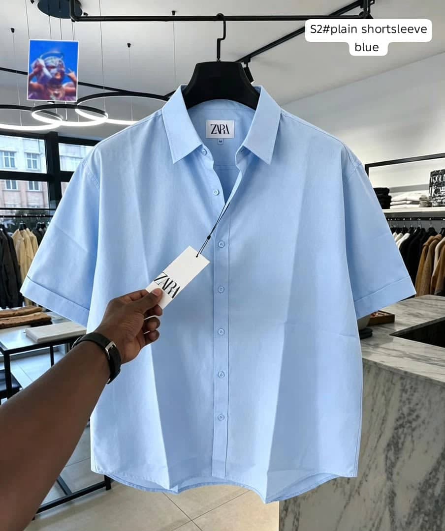 Zara plain short sleeve shirt in light blue on hanger.