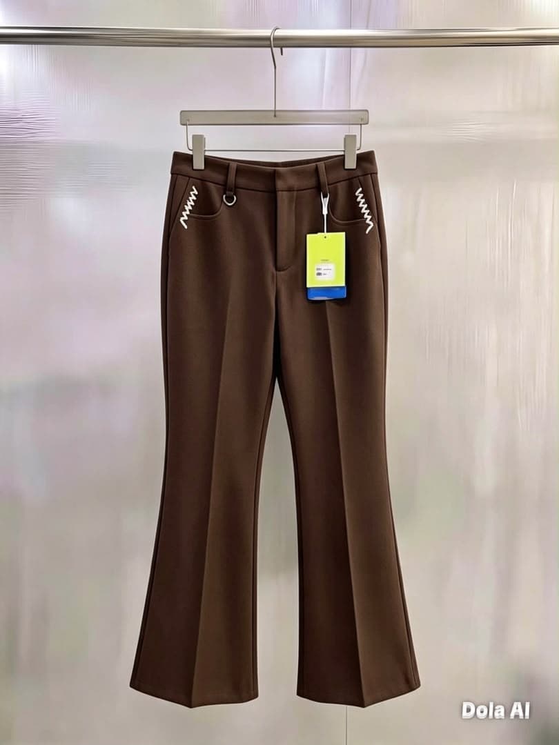 Brown flare trousers with white zigzag pocket embroidery, hanging view.