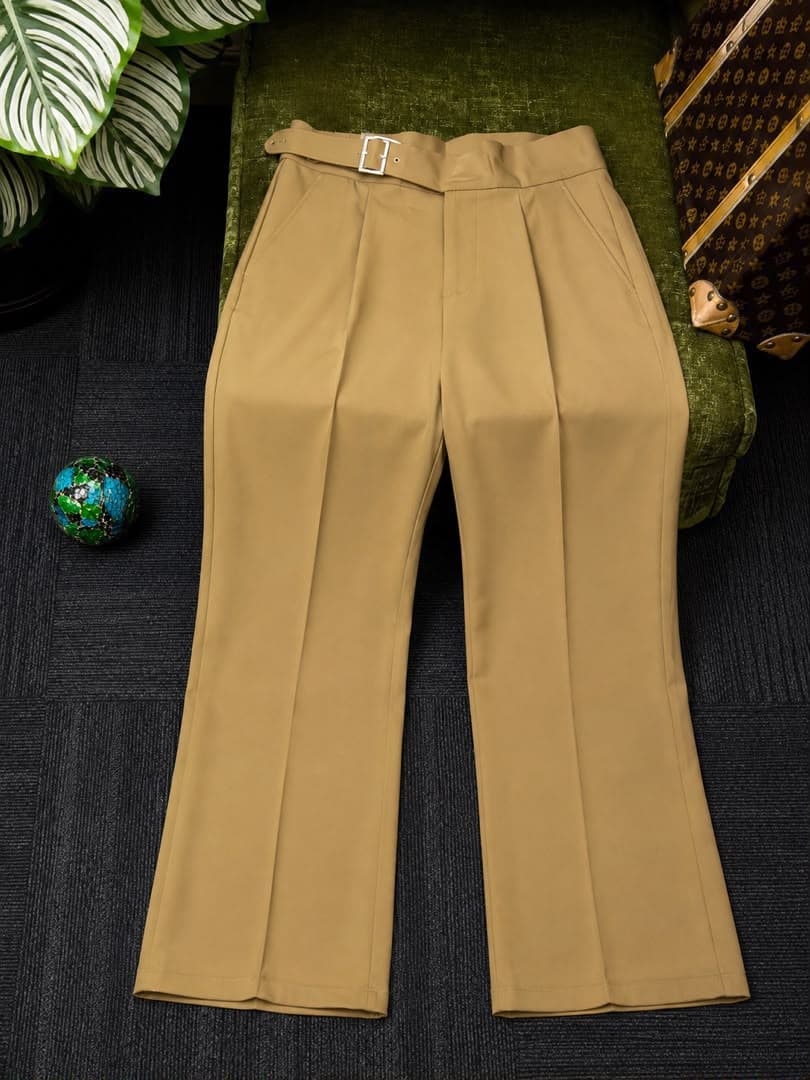 Beige high-waisted flare trousers with belt, flat lay view.