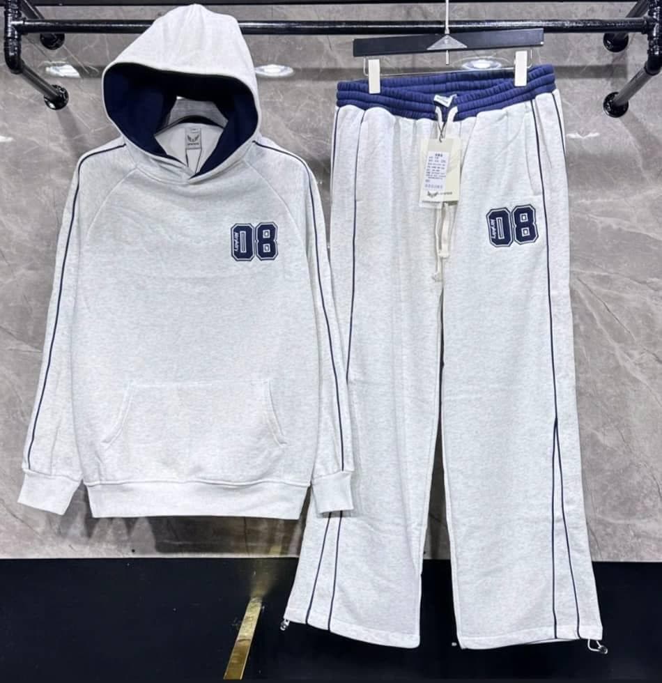 Light gray hoodie and pants with navy 08 logos and trim hanging on rack.