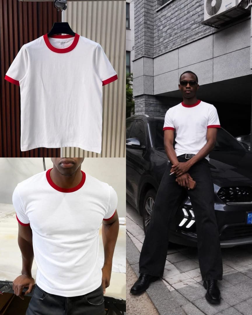 White t-shirt with red contrast trim on neck and cuffs, shown on hanger and model.