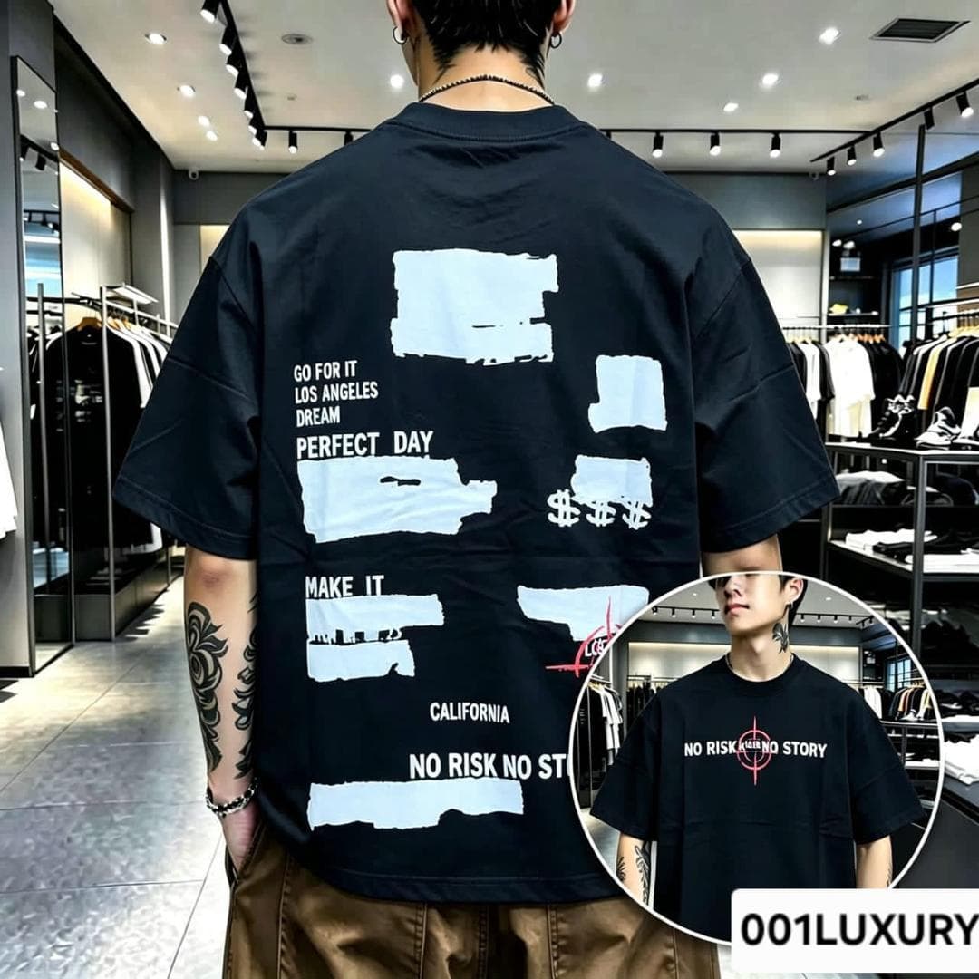 Man in black oversized T-shirt with white torn paper text collage on the back.
