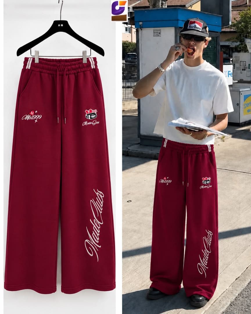 Maroon MadeClubs joggers with multiple embroidered graphics shown on hanger and model.