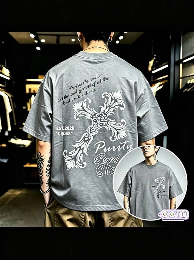 Model from behind wearing gray oversized T-shirt with ornate cross graphic print on back and front inset view.