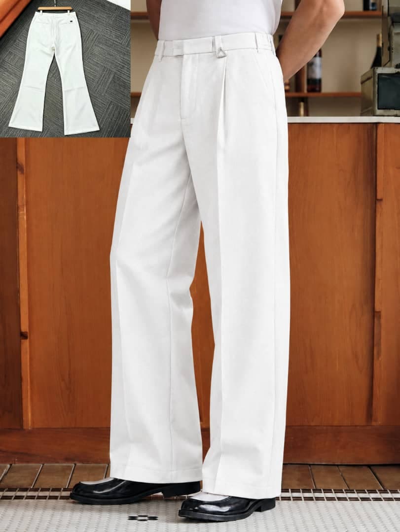 Model wearing brown pleated flare trousers with white t-shirt and side buckle details, flat lay inset.