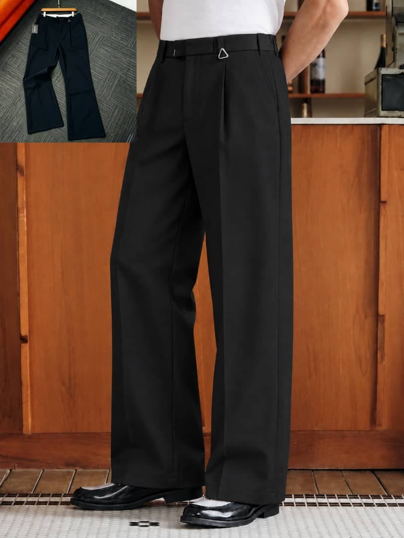 Model wearing black pleated flare trousers with hanging tag and side adjusters, flat lay inset.