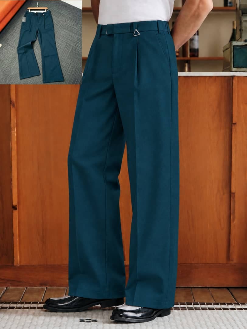 Model wearing white pleated flare trousers with side adjusters, flat lay inset on carpet.