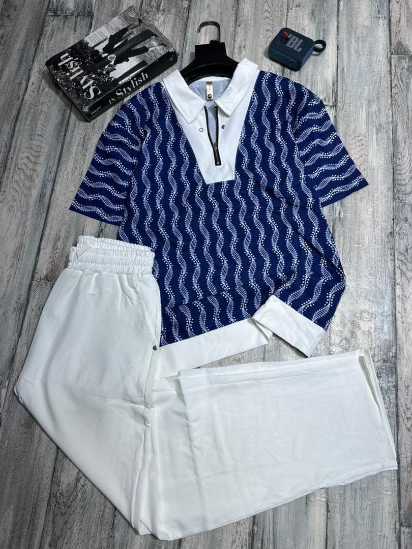 Leopard print zip polo shirt with black pants two-piece set on wooden floor with accessories.