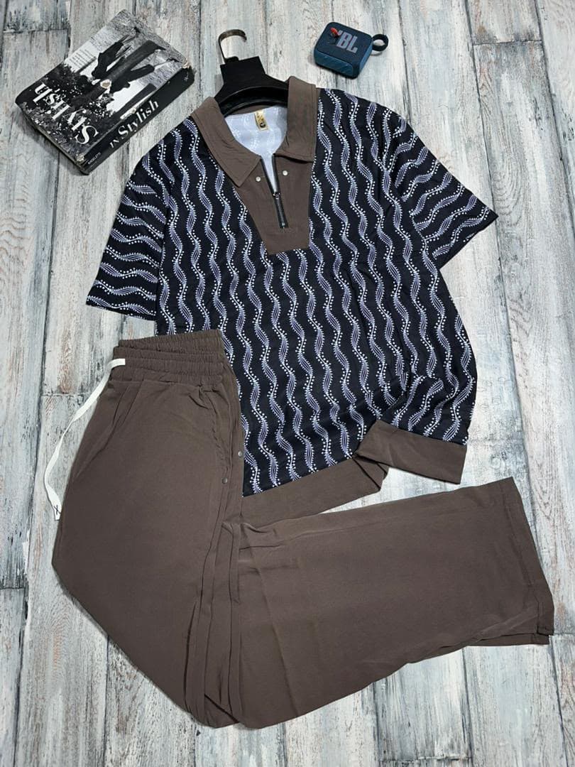Multiple abstract and printed two-piece sets displayed together on gray surface.