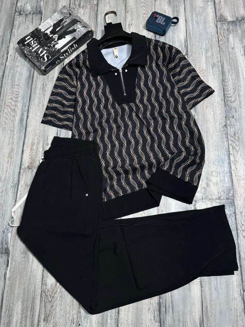 Black and white abstract print zip polo shirt with white pants two-piece set.