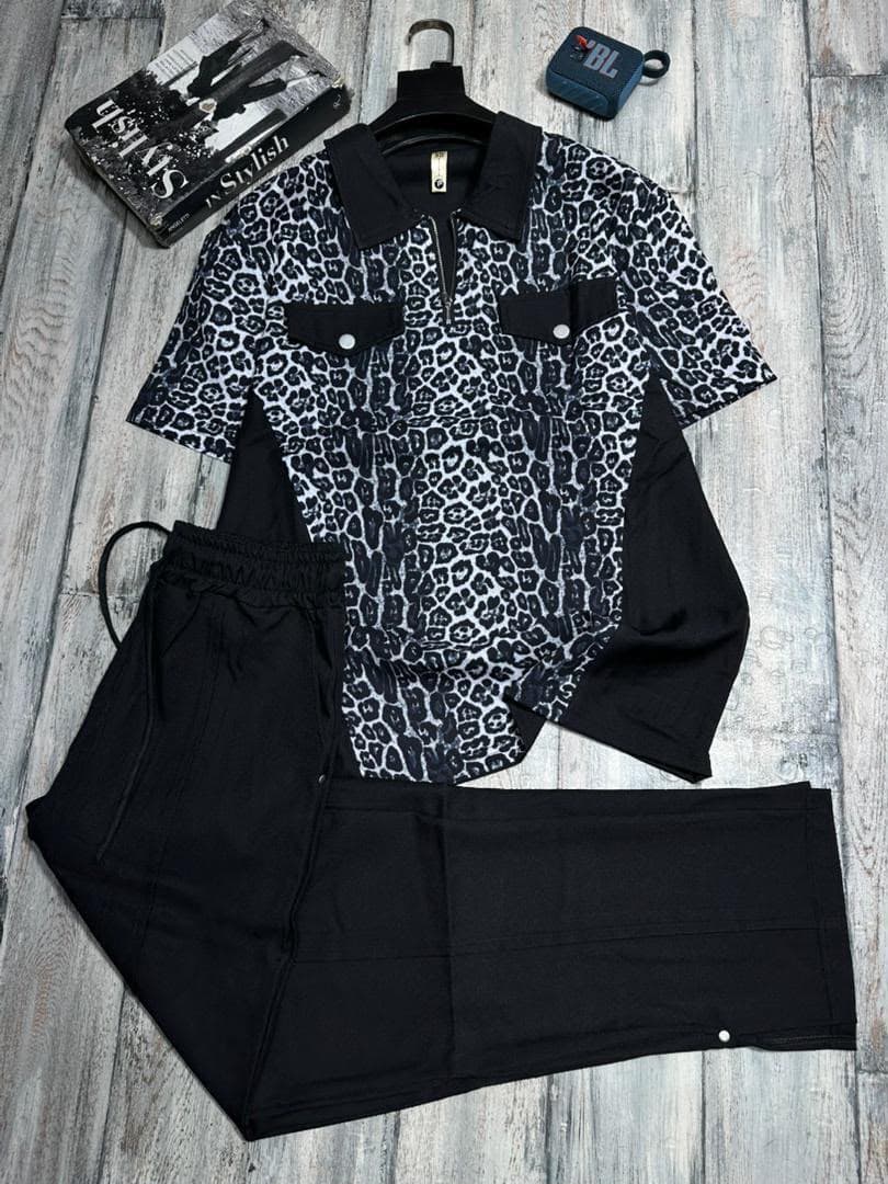 Navy blue wavy print zip polo shirt with white pants two-piece set.