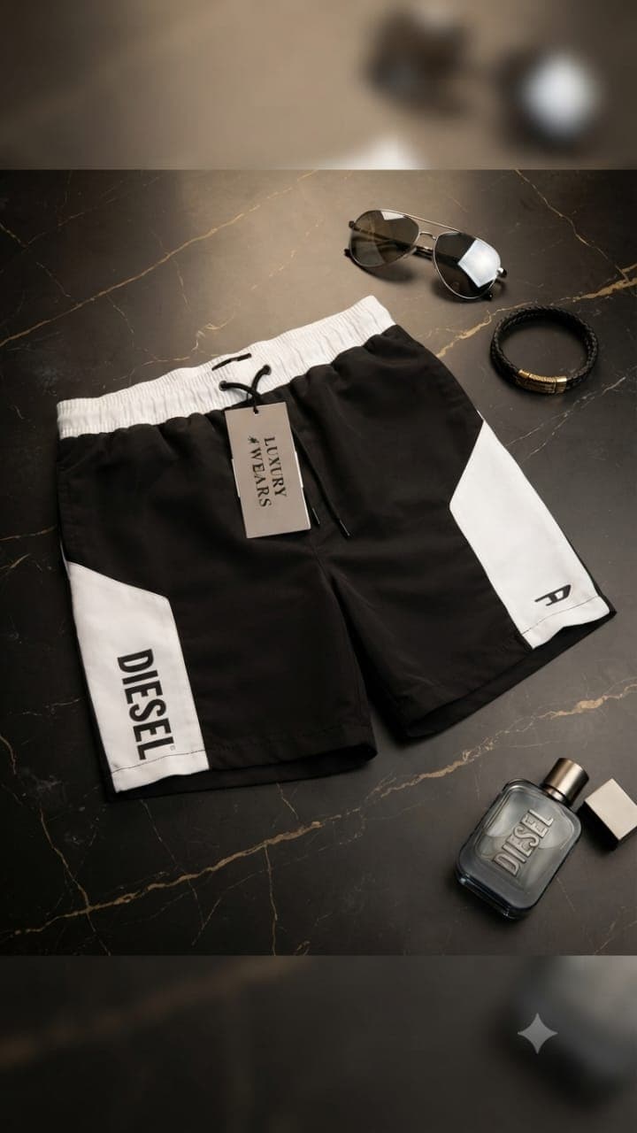 Black and white Diesel colorblock shorts with DIESEL text on side.