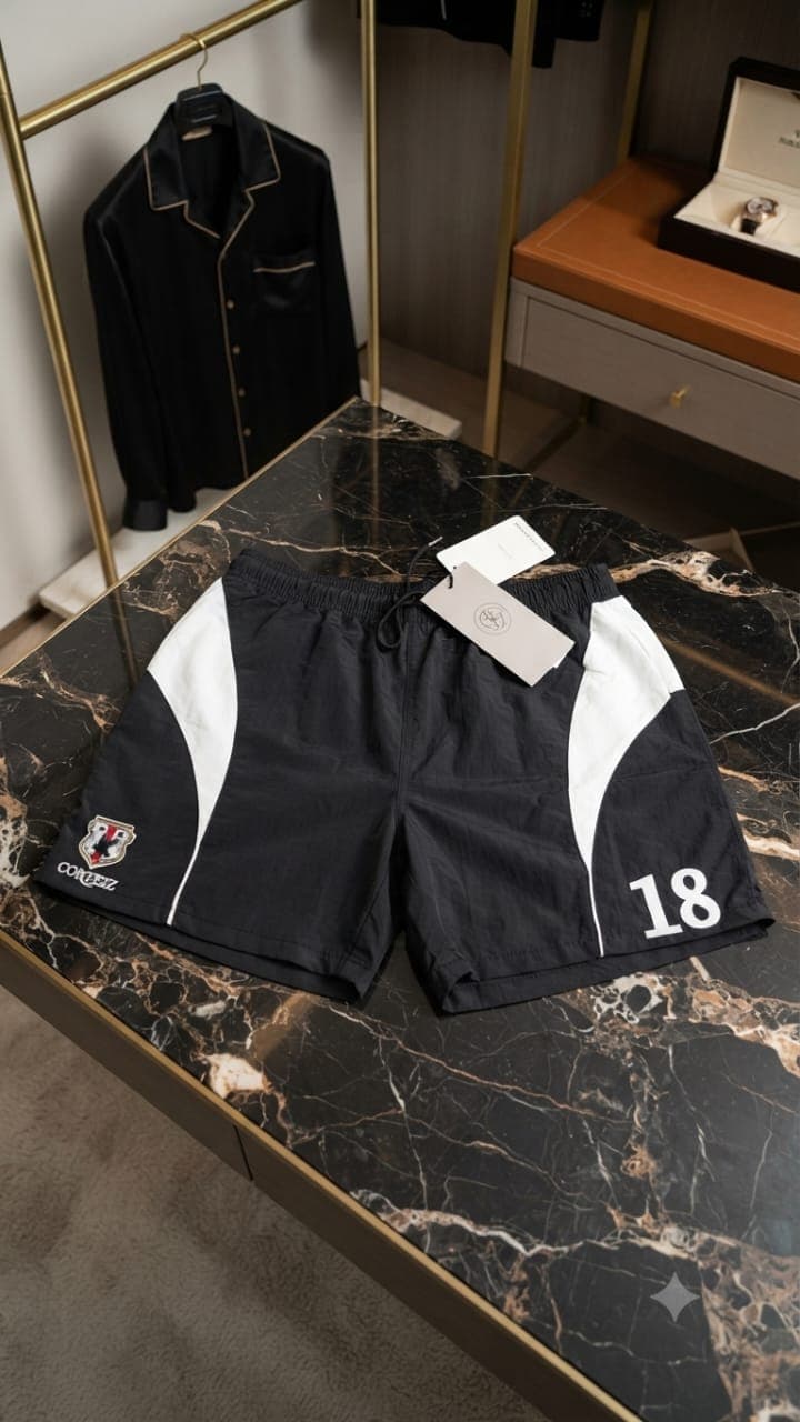 Black Corteiz 18 colorblock shorts with crest logo and tag.