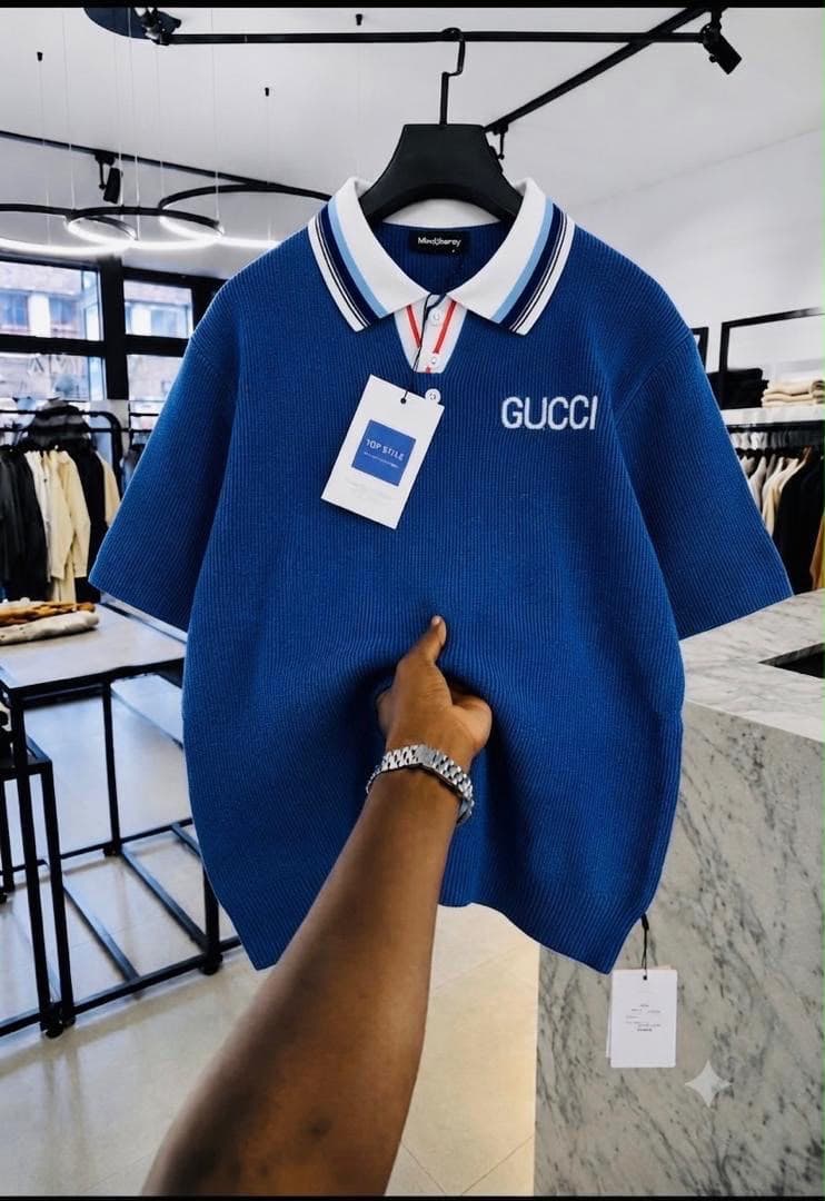 Blue Gucci embroidered ribbed polo shirt with striped collar.