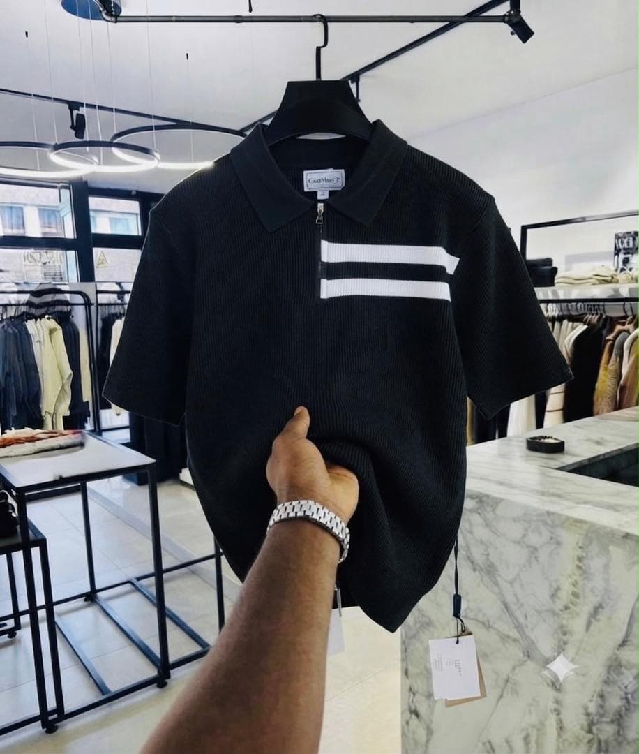 Black ribbed zip polo shirt with white chest stripes.
