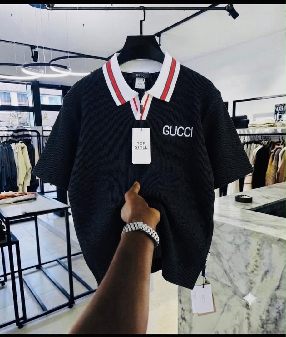 Black Gucci embroidered ribbed polo shirt with striped collar.