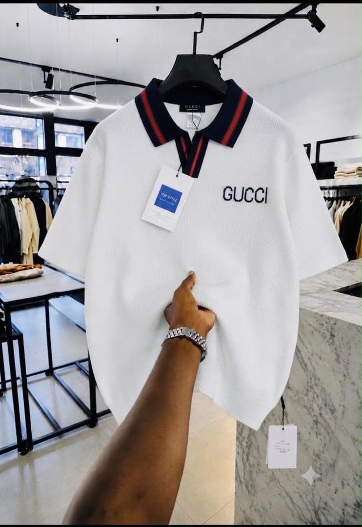 White Gucci embroidered ribbed polo shirt with striped collar.