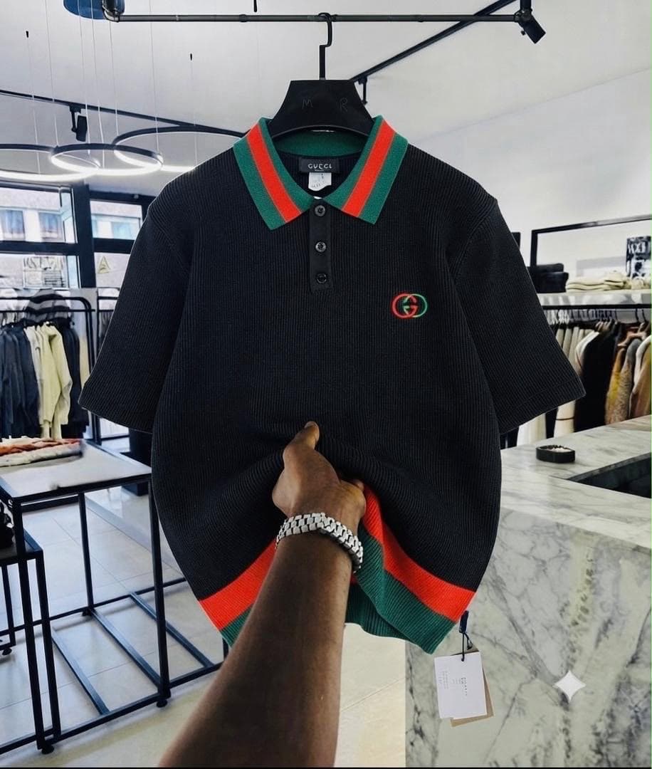 Black Gucci GG ribbed polo shirt with green and red striped collar.