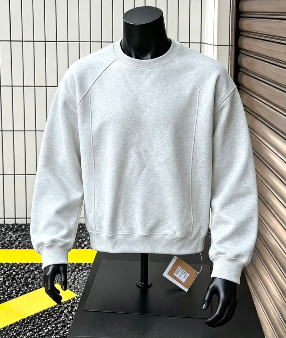 Gray crewneck sweatshirt with chest logo and panel on mannequin.