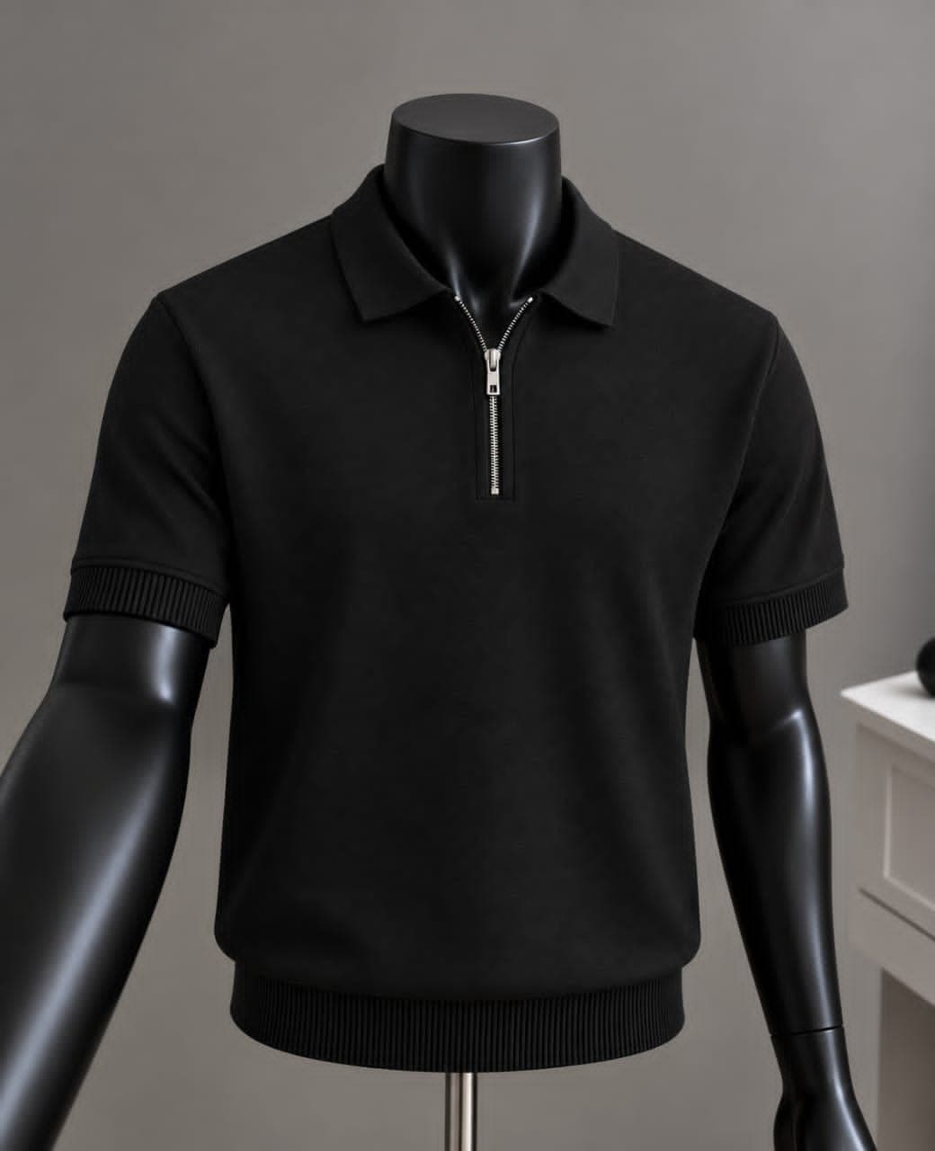 Black quarter-zip polo shirt on mannequin with ribbed trims.