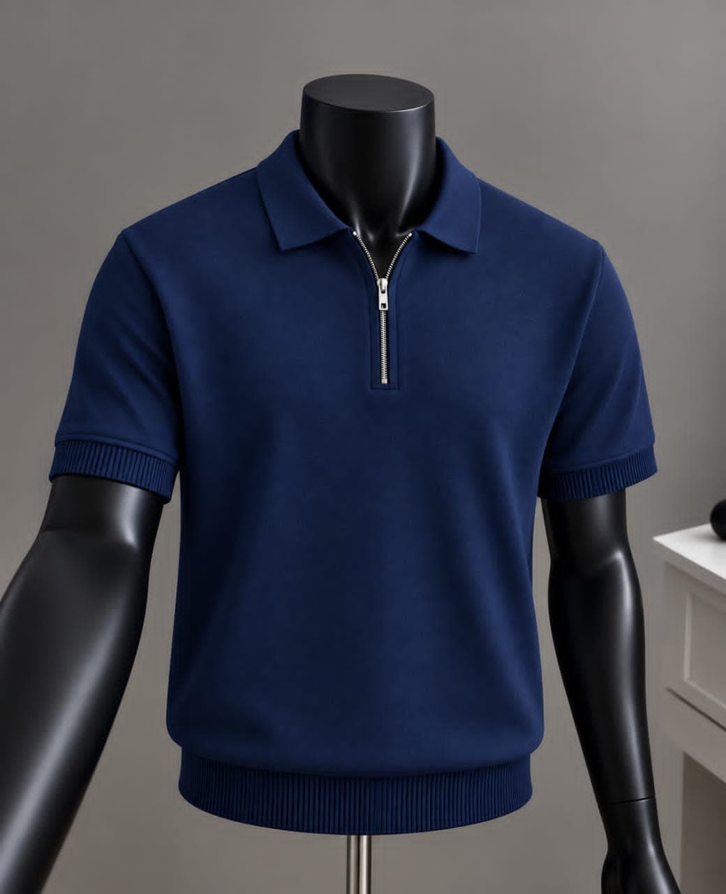 Navy quarter-zip polo shirt on mannequin with ribbed trims.