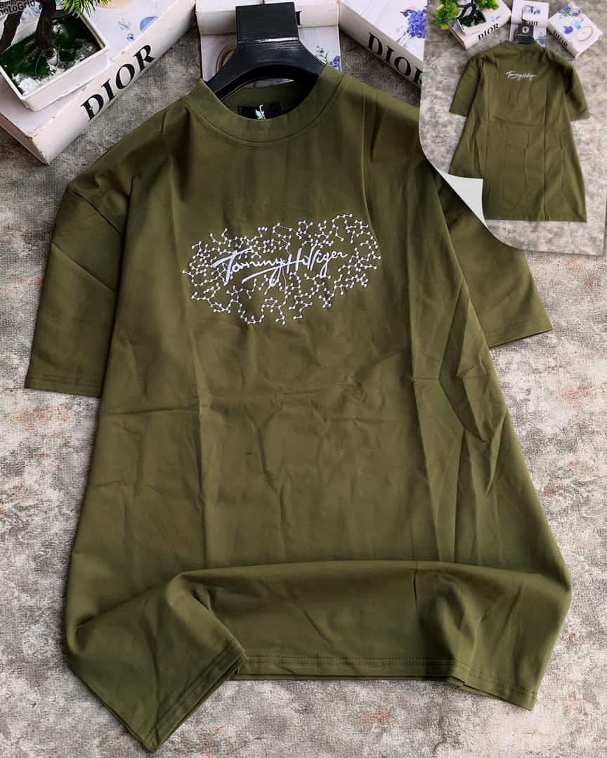Olive t-shirt with red W LIFEWORK logo on chest and sleeve text shown with folded inset.