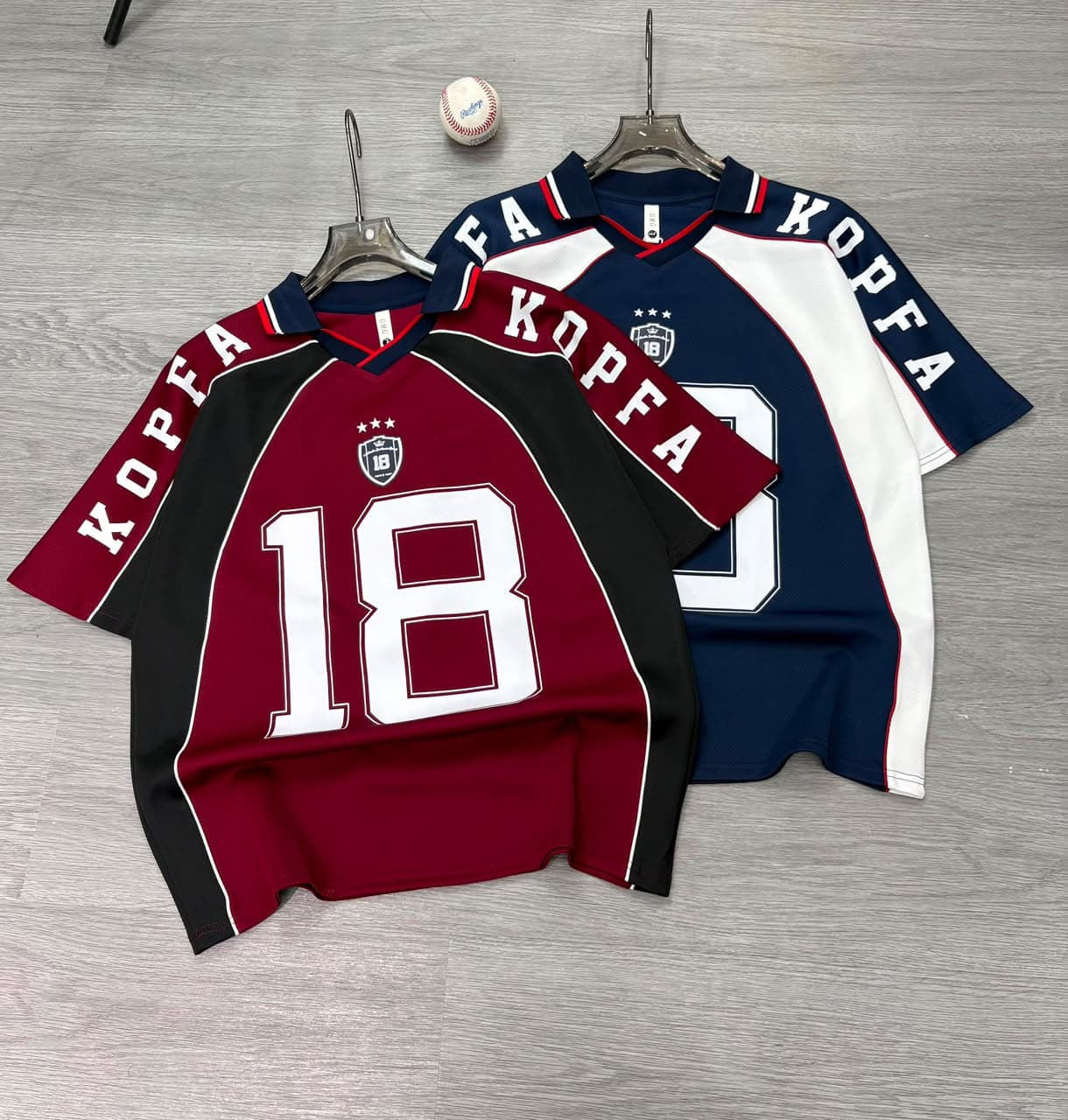 Burgundy and navy Kopfa 18 jerseys laid flat side by side showing both colorways.