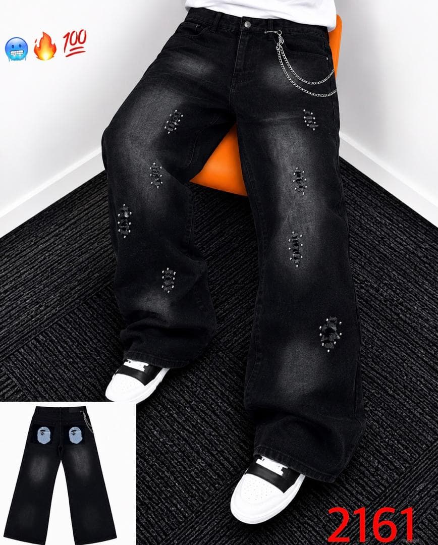 Model wearing black distressed rhinestone baggy jeans with waist chain and white sneakers, inset shows back with graphic pockets.