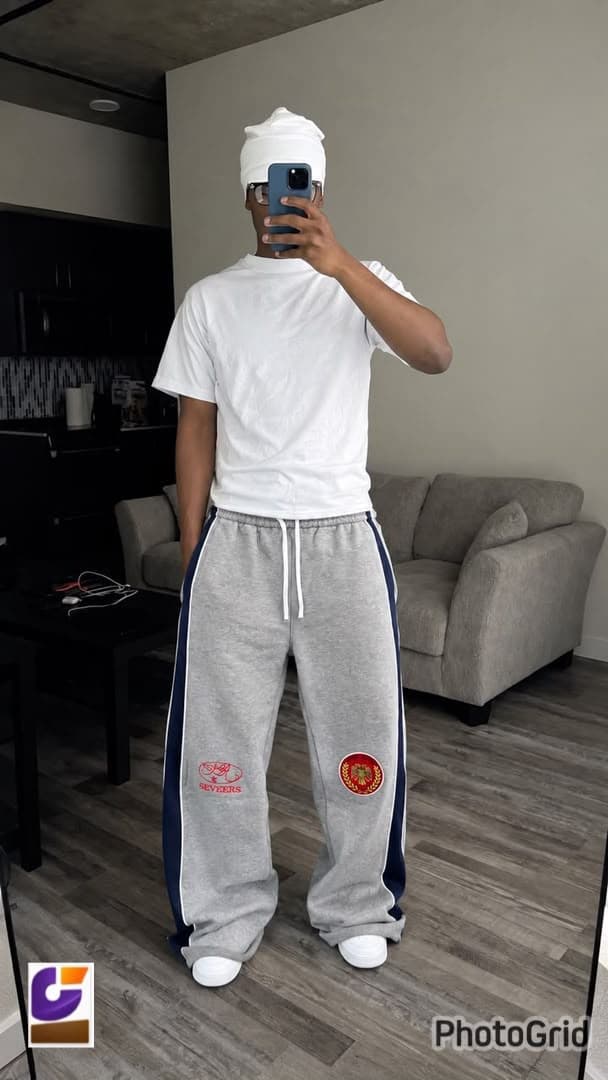Model wearing gray side-stripe joggers with SEVEERS embroidery.