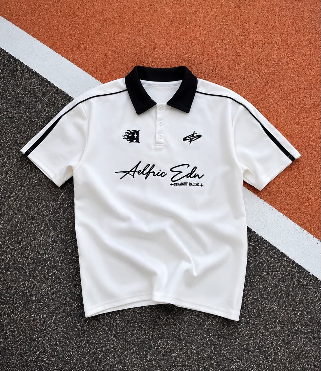 Burgundy Aelfric Edn polo shirt flat lay on textured background.