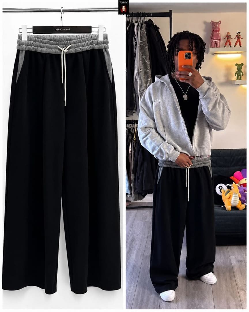 Black joggers on hanger next to model with dreadlocks wearing them with gray zip-up hoodie.