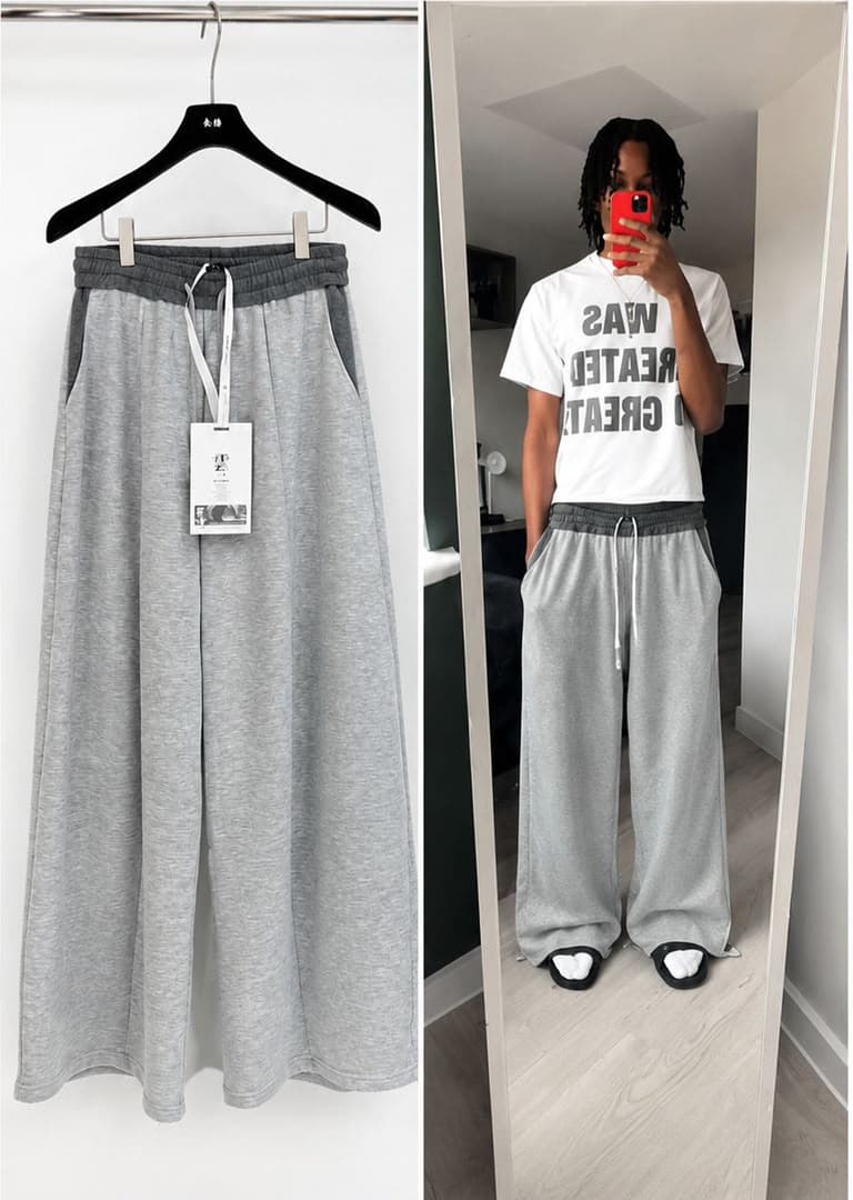Gray joggers on hanger with tag next to mirror selfie of model in white graphic t-shirt and gray joggers.