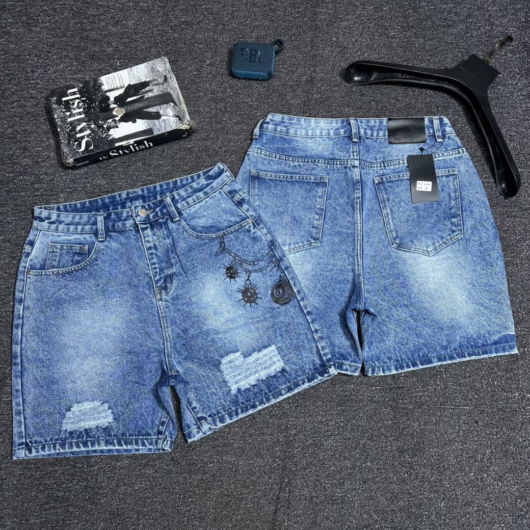 Black denim shorts with red star embroidery on back pocket.
