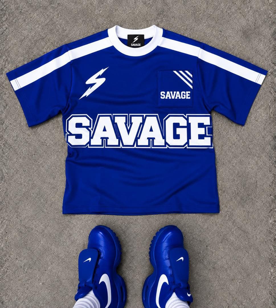 Blue Savage t-shirt with white lightning bolt, large SAVAGE print, chest pocket and matching blue sneakers.