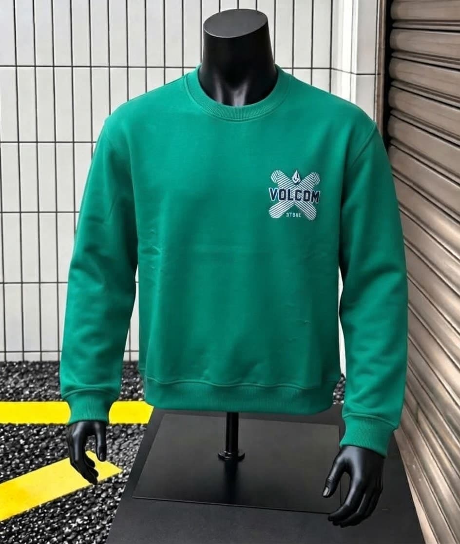 Mannequin wearing bright green Volcom sweatshirt with chest logo.