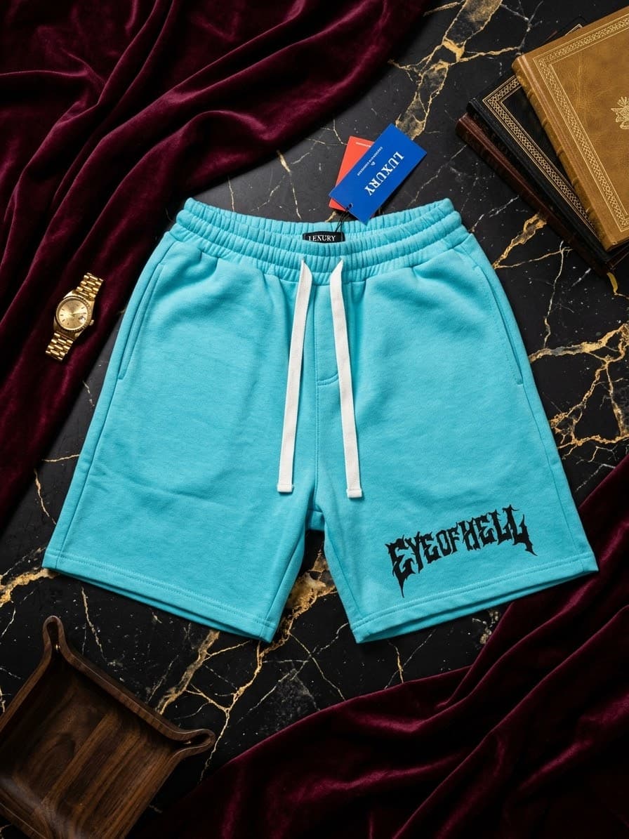 Turquoise fleece shorts with black EYE OF HELL gothic print on marble and velvet background.
