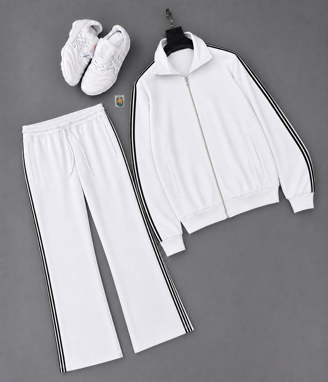 White unisex track suit set showing zip jacket, striped trousers and accessories.