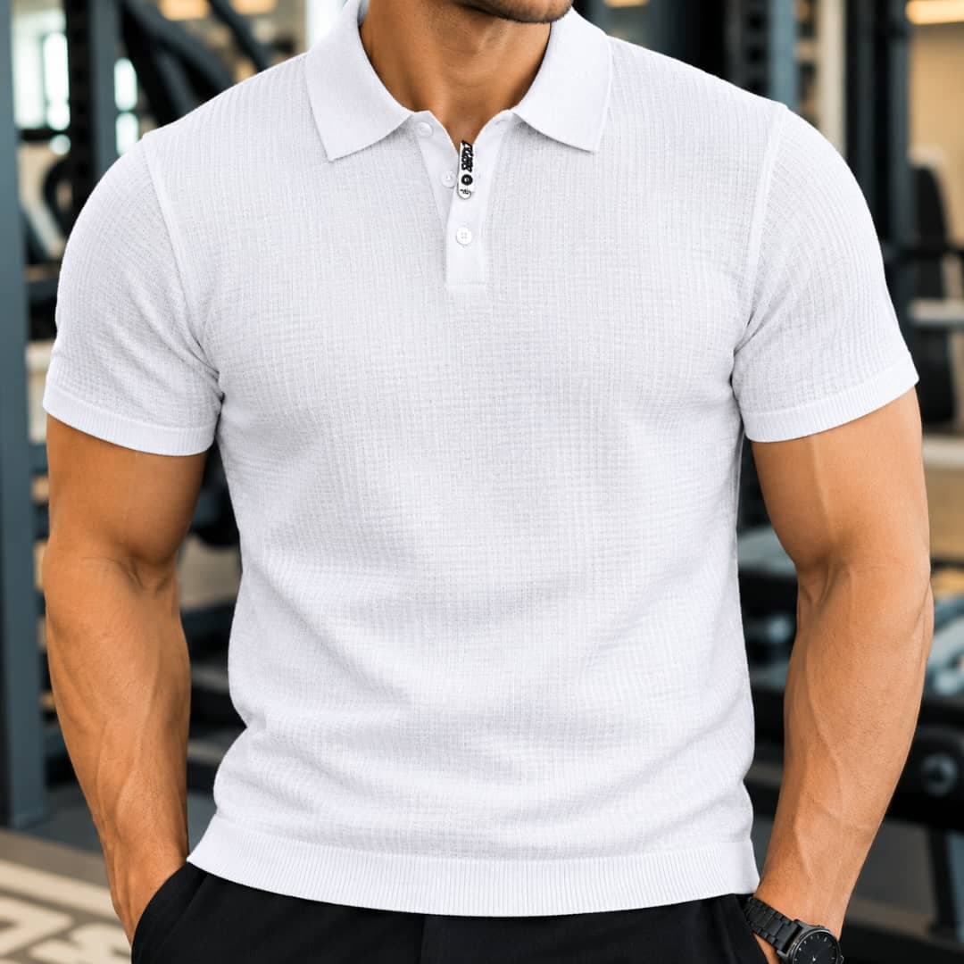 Man wearing white waffle knit polo shirt with visible tag detail.