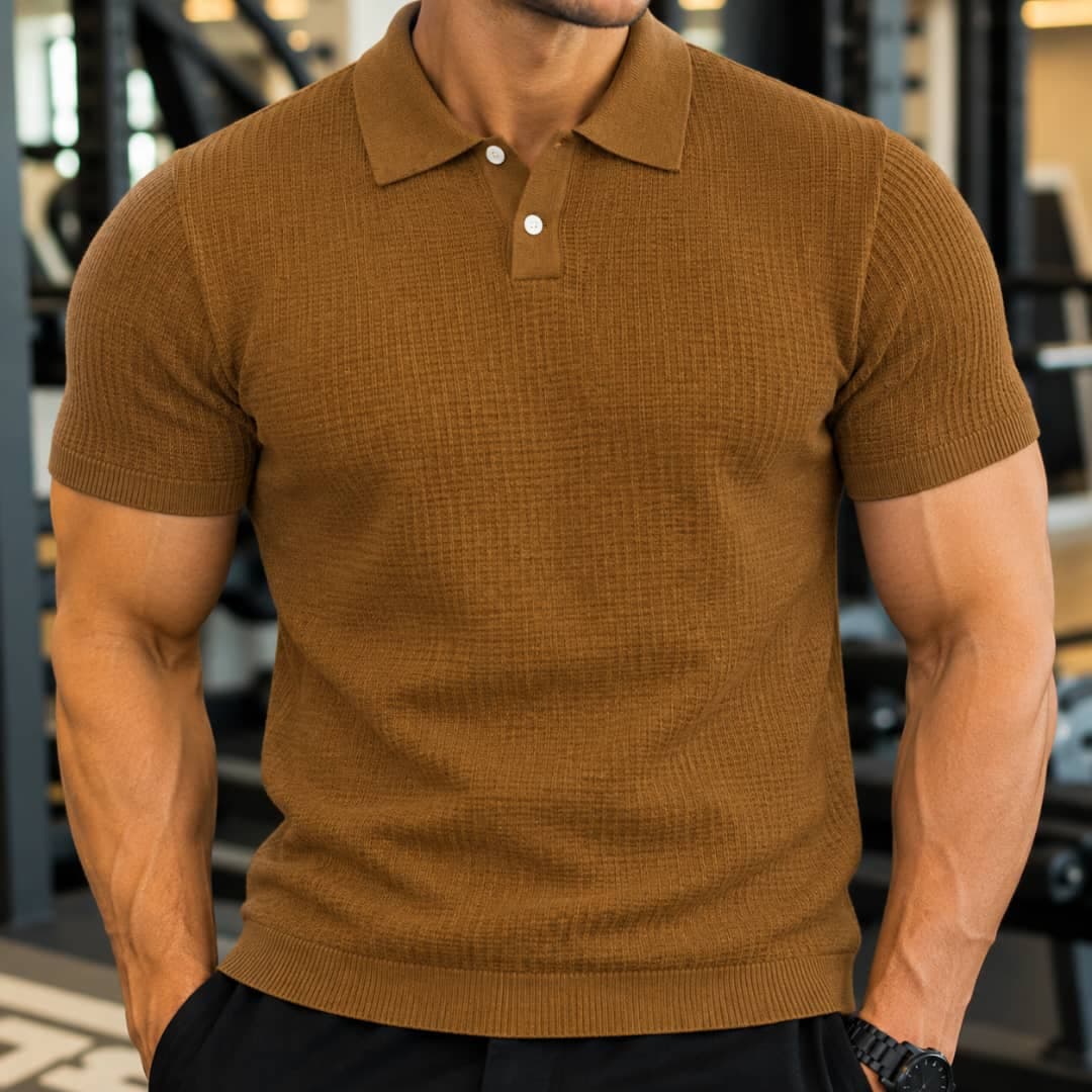 Man wearing brown waffle knit polo shirt in gym setting.