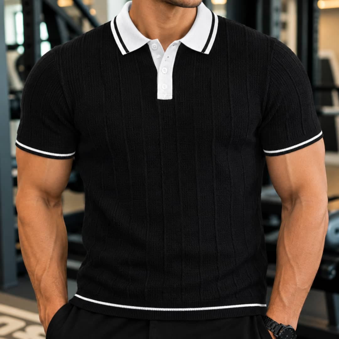 Man wearing black ribbed polo shirt with white contrast collar and trim.