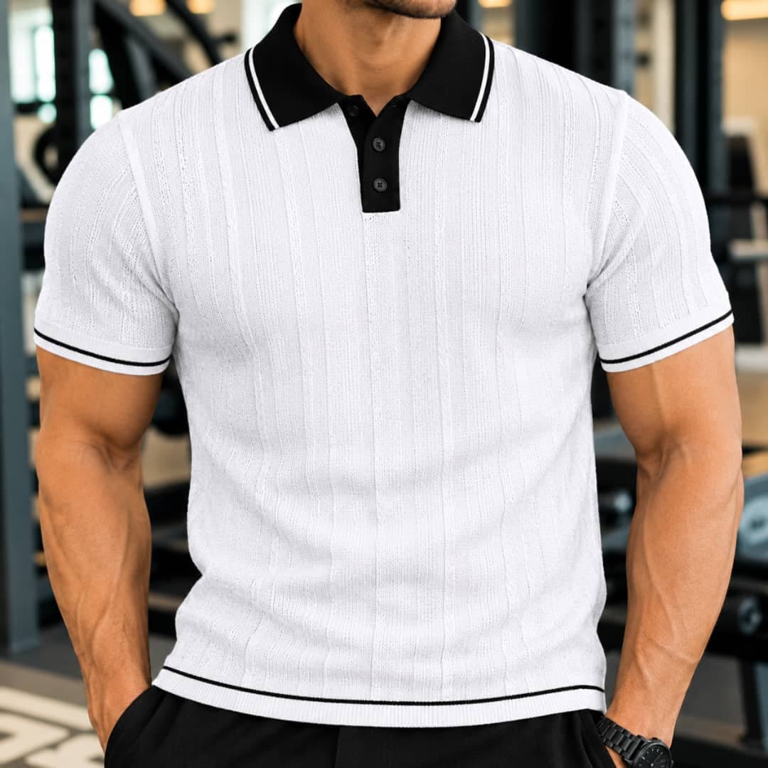 Man wearing white ribbed polo shirt with black contrast collar and trim.