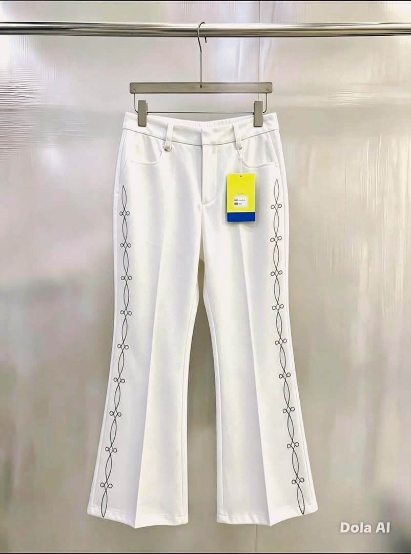 White flare trousers with black chain embroidery on sides.
